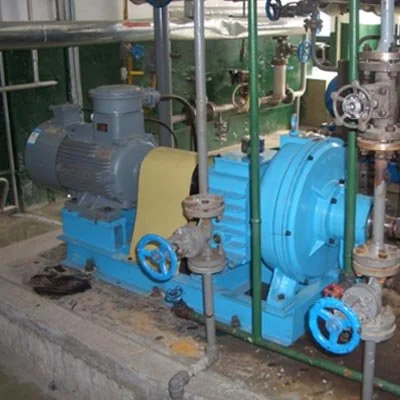 Pump and motor installed alongside vertical process pipework